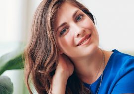 attractive-young-woman-sitting-at-a-table-P7FWDED