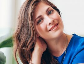 attractive-young-woman-sitting-at-a-table-P7FWDED