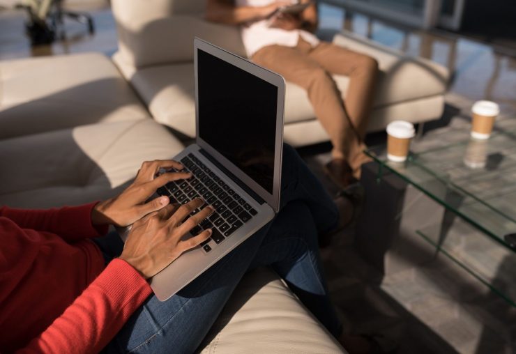 female-executive-using-laptop-in-the-office-with-c-NVS23C8