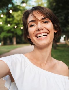 smiling-young-girl-taking-a-selfie-NR2ZWMP