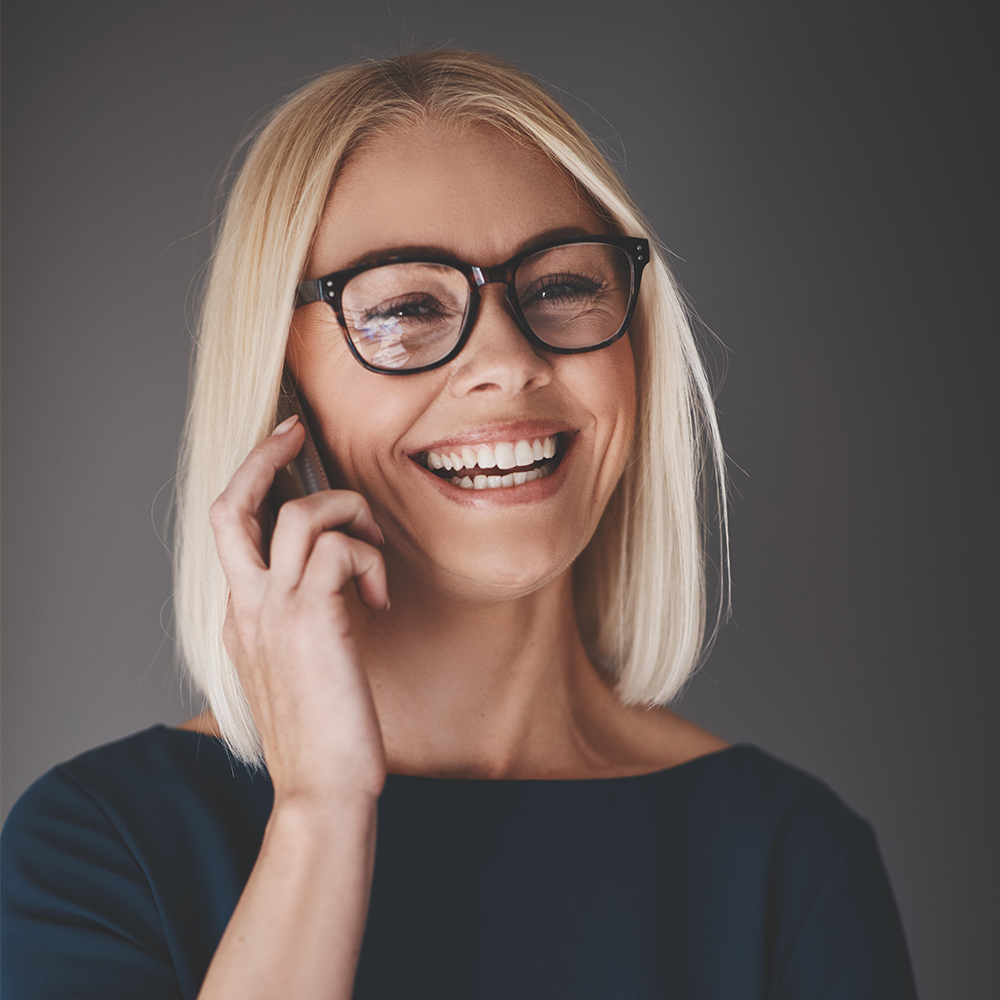 laughing-busineswoman-talking-on-her-cellphone-9K4LH7Z